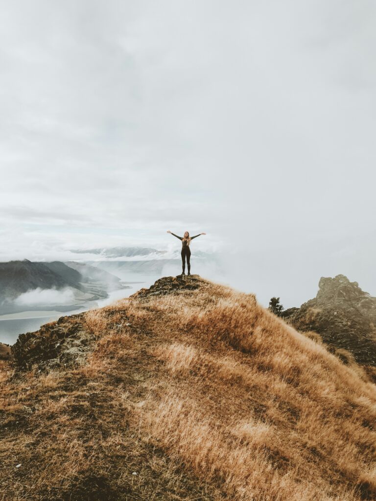 A woman at the top of a mountain